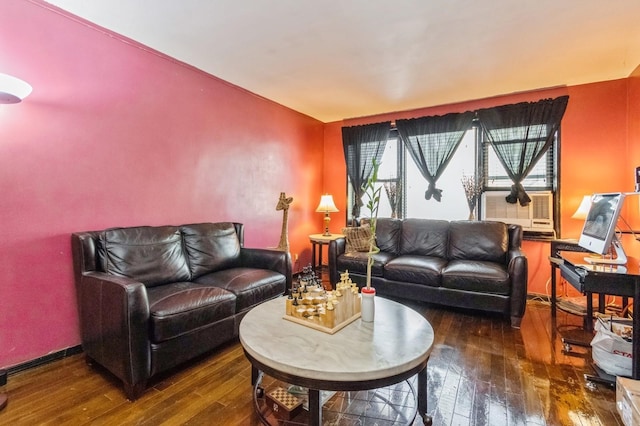 living area with hardwood / wood-style flooring and baseboards