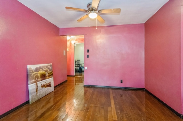 unfurnished room with baseboards, a ceiling fan, and wood-type flooring