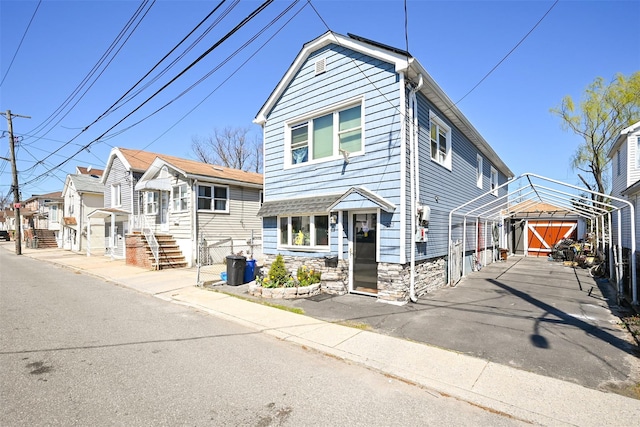 102-25 163rd Dr, Howard Beach, NY 11414 - traditional-style home with a detached carport and stone siding