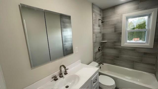 bathroom with vanity, bathtub / shower combination, and toilet