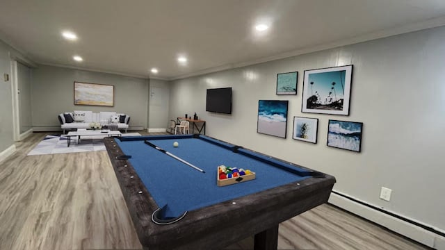 rec room with recessed lighting, baseboards, baseboard heating, and wood finished floors