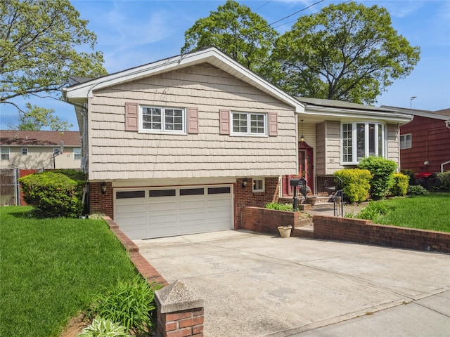 915 Derrick Adkins Ln, West Hempstead, NY 11552 - view of front of home featuring an attached garage, concrete driveway, and brick siding