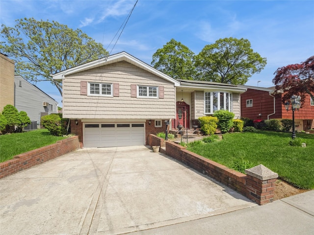 915 Derrick Adkins Ln, West Hempstead, NY 11552 - view of front of home with a garage, concrete driveway, and a front yard