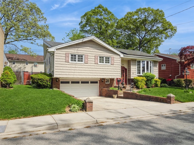 915 Derrick Adkins Ln, West Hempstead, NY 11552 - view of front of home with concrete driveway, a garage, and brick siding