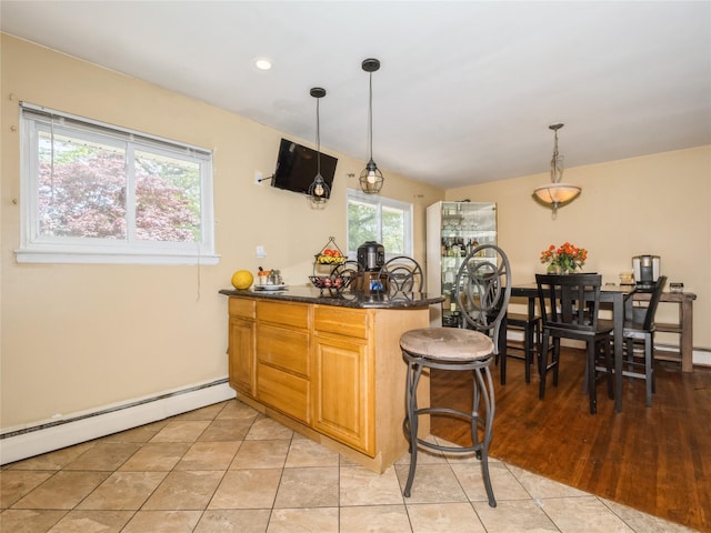 915 Derrick Adkins Ln, West Hempstead, NY 11552 - kitchen with a baseboard radiator, a peninsula, dark countertops, hanging light fixtures, and recessed lighting