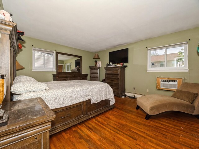 915 Derrick Adkins Ln, West Hempstead, NY 11552 - bedroom featuring dark wood-style flooring, a wall mounted air conditioner, multiple windows, and a baseboard radiator