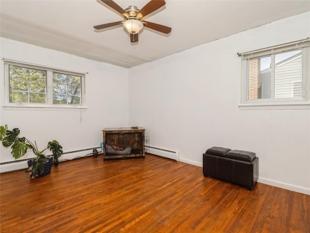 915 Derrick Adkins Ln, West Hempstead, NY 11552 - empty room with wood finished floors, a baseboard heating unit, ceiling fan, and baseboards