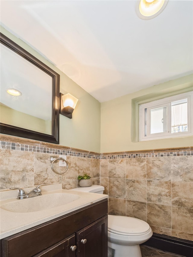 915 Derrick Adkins Ln, West Hempstead, NY 11552 - half bath featuring tile walls, toilet, vanity, and wainscoting