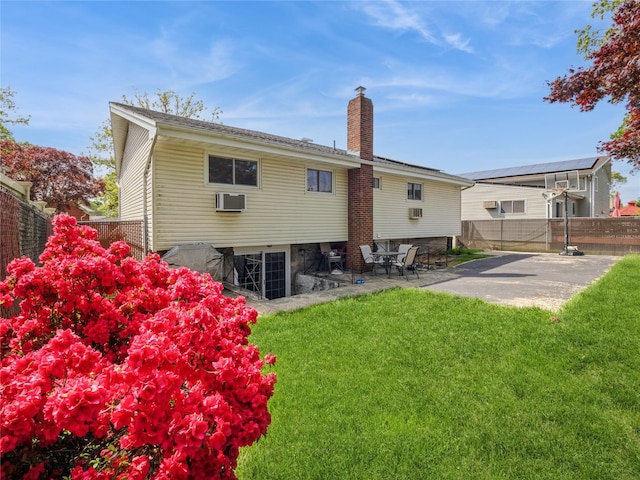 915 Derrick Adkins Ln, West Hempstead, NY 11552 - rear view of property with a chimney, a patio area, and a wall mounted air conditioner