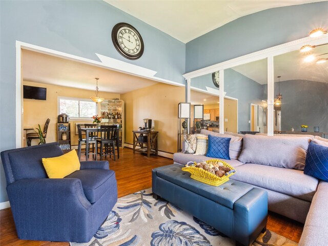 915 Derrick Adkins Ln, West Hempstead, NY 11552 - living area featuring wood finished floors, high vaulted ceiling, a skylight, and baseboards