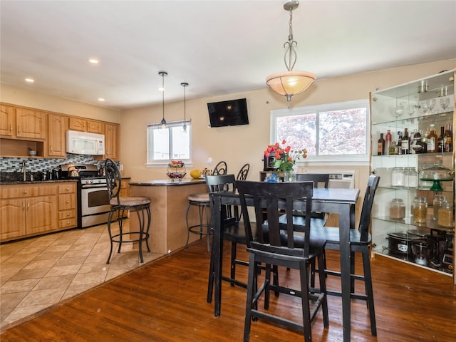 915 Derrick Adkins Ln, West Hempstead, NY 11552 - dining space with light wood finished floors and recessed lighting