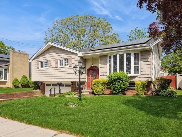 915 Derrick Adkins Ln, West Hempstead, NY 11552 - raised ranch featuring an attached garage, a front lawn, and solar panels