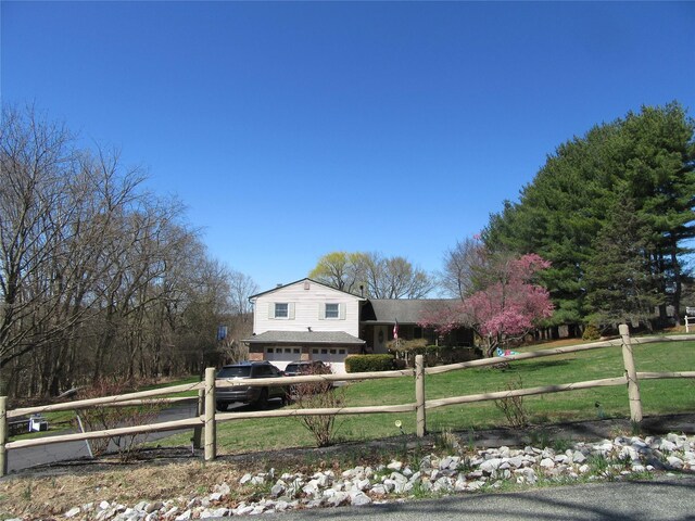 29 Beattie Rd, Washingtonville, NY 10992 - view of front of home with driveway, an attached garage, fence private yard, and a front lawn