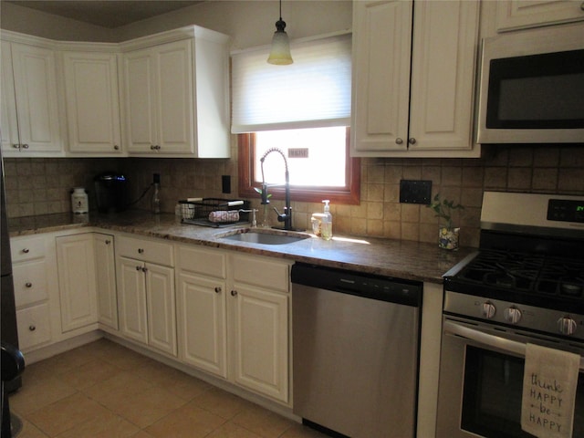29 Beattie Rd, Washingtonville, NY 10992 - kitchen featuring a sink, stainless steel appliances, white cabinetry, light tile patterned floors, and backsplash