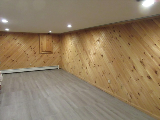29 Beattie Rd, Washingtonville, NY 10992 - finished basement with wood walls, a baseboard radiator, recessed lighting, and wood finished floors