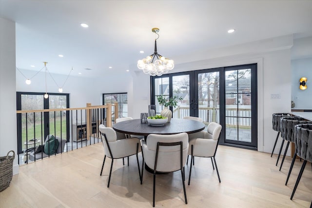 64 Jane Ct, Westbury, NY 11590 - dining room with recessed lighting, french doors, light wood-type flooring, and an inviting chandelier