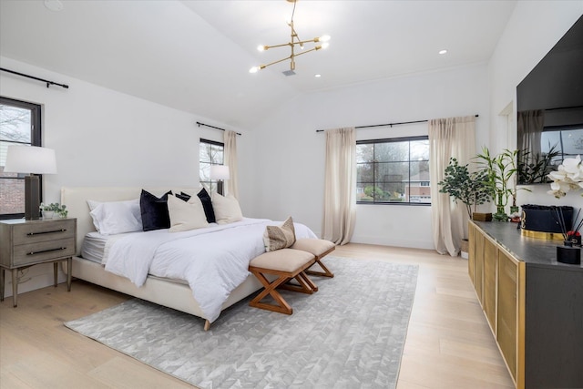 64 Jane Ct, Westbury, NY 11590 - bedroom with light wood-type flooring, multiple windows, an inviting chandelier, and vaulted ceiling