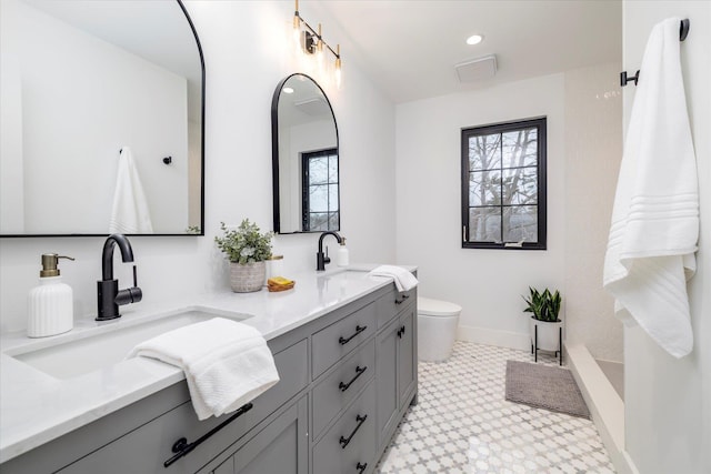 64 Jane Ct, Westbury, NY 11590 - bathroom featuring toilet, a sink, and a wealth of natural light