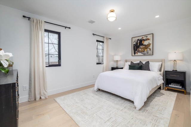64 Jane Ct, Westbury, NY 11590 - bedroom featuring light wood-style floors, multiple windows, and visible vents