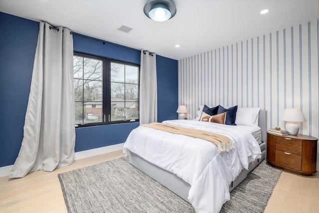 64 Jane Ct, Westbury, NY 11590 - bedroom with wood finished floors, an accent wall, visible vents, and recessed lighting