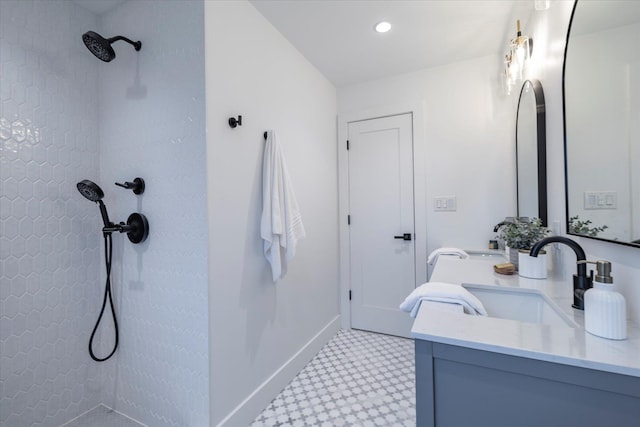 64 Jane Ct, Westbury, NY 11590 - bathroom featuring baseboards, double vanity, a sink, and a tile shower