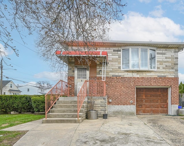 97 Arlington Ave, Valley Stream, NY 11580 - view of front of property with an attached garage, driveway, stone siding, and brick siding