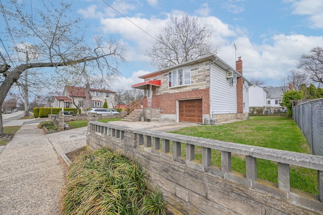 97 Arlington Ave, Valley Stream, NY 11580 - view of home's exterior with a yard, fence, an attached garage, a chimney, and driveway