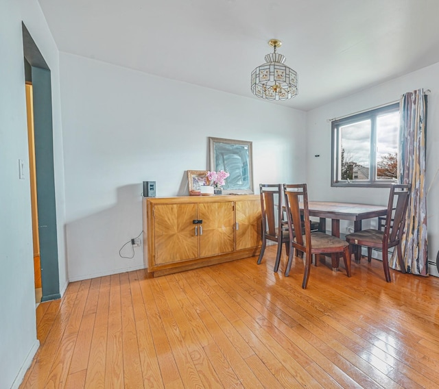 97 Arlington Ave, Valley Stream, NY 11580 - dining area with light wood-style flooring and a notable chandelier