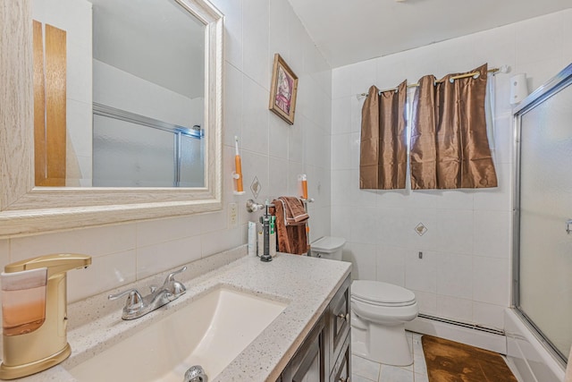 97 Arlington Ave, Valley Stream, NY 11580 - full bathroom with baseboard heating, tile walls, backsplash, and toilet