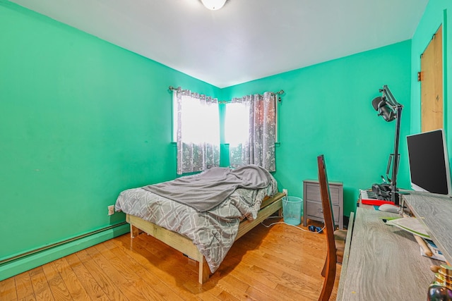 97 Arlington Ave, Valley Stream, NY 11580 - bedroom featuring a baseboard heating unit and hardwood / wood-style floors