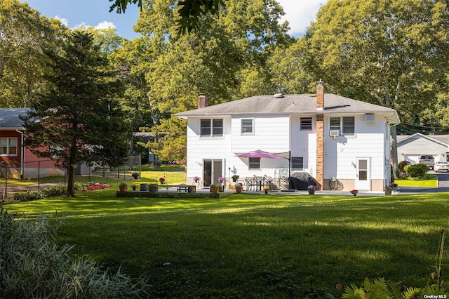 rear view of property with a patio area, a lawn, and a chimney