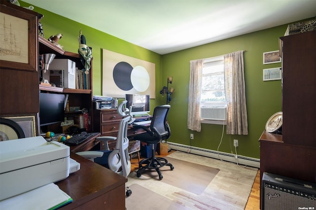 office with cooling unit, a baseboard heating unit, and wood finished floors