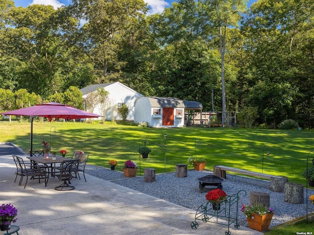 exterior space with an outdoor structure, an outdoor fire pit, and a storage unit