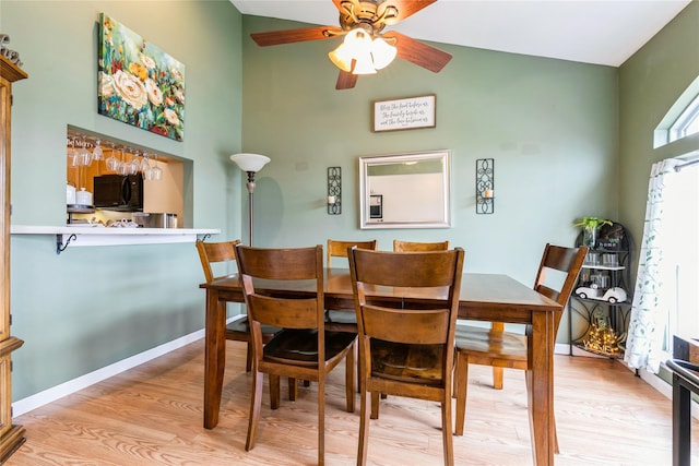 dining space featuring light wood-type flooring and ceiling fan
