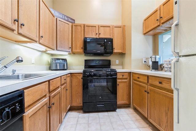 kitchen with light countertops, light tile patterned floors, a sink, and black appliances