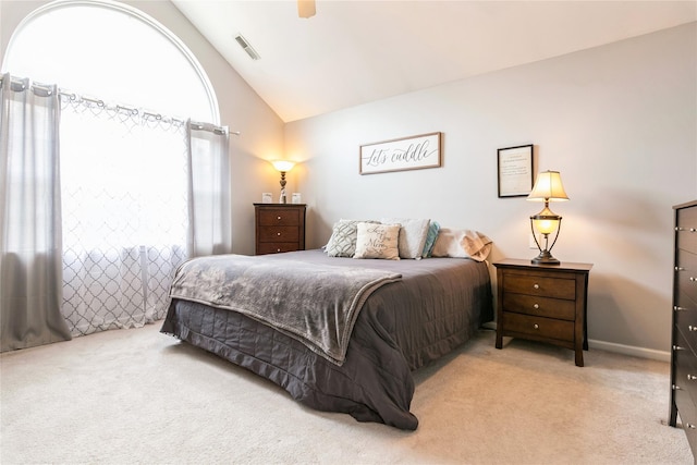 carpeted bedroom featuring vaulted ceiling, visible vents, and ceiling fan
