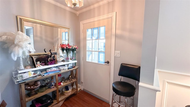 entryway featuring ornamental molding and wood finished floors