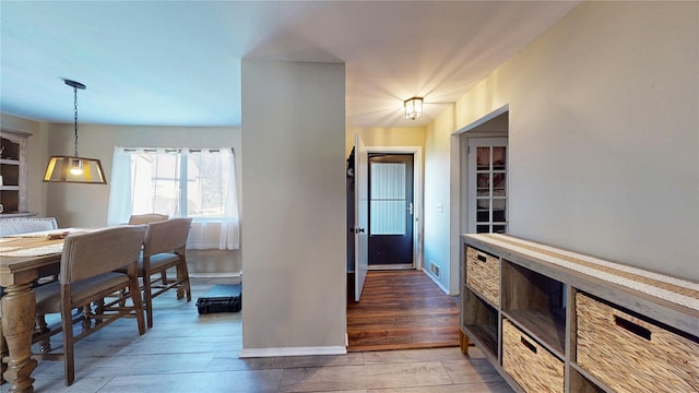 interior space with baseboards and wood finished floors