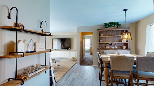 dining space featuring baseboards and wood finished floors