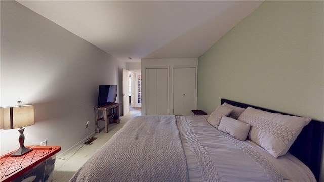 carpeted bedroom featuring two closets