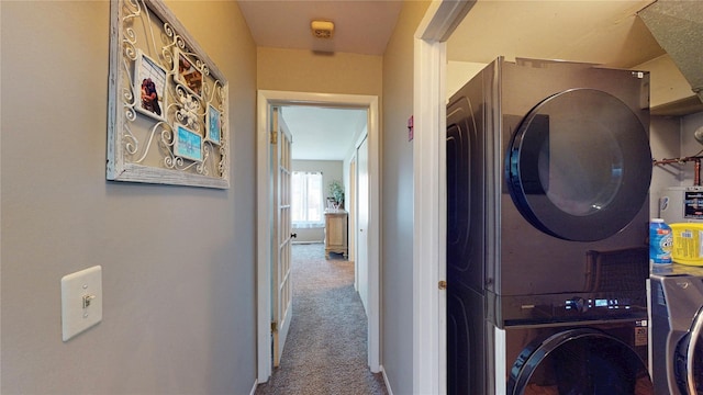 laundry area with carpet, laundry area, and stacked washer / dryer