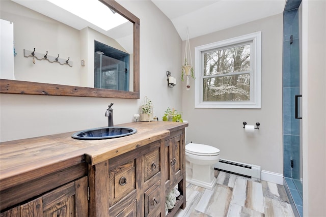 bathroom featuring a baseboard heating unit, lofted ceiling, toilet, and a shower with shower door