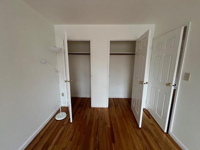 41-23 76th St # 2B, Elmhurst, NY 11373 - unfurnished bedroom with two closets and wood finished floors