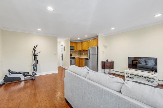4410 Wilshire Ln Unit 4410, Oakdale, NY 11769 - living room featuring baseboard heating, recessed lighting, baseboards, light wood-style floors, and crown molding