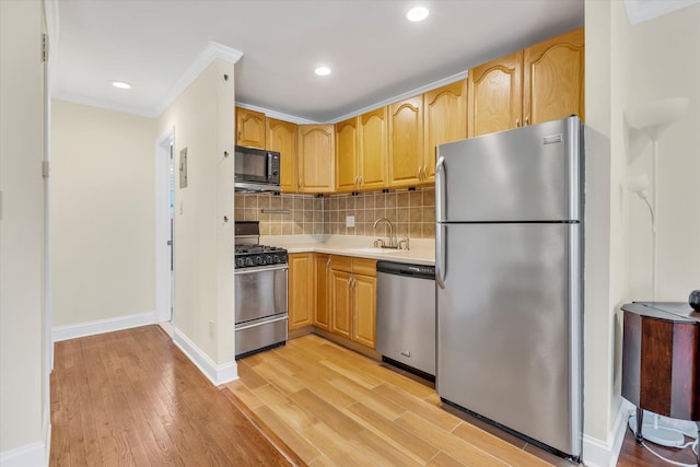 4410 Wilshire Ln Unit 4410, Oakdale, NY 11769 - kitchen featuring stainless steel appliances, a sink, light wood-style floors, light countertops, and decorative backsplash