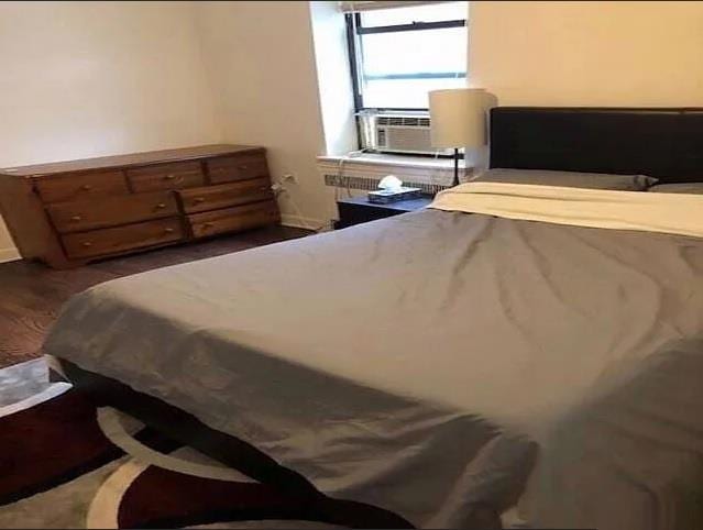 7 Bond St Unit 2C, Great Neck, NY 11021 - bedroom with cooling unit and wood finished floors