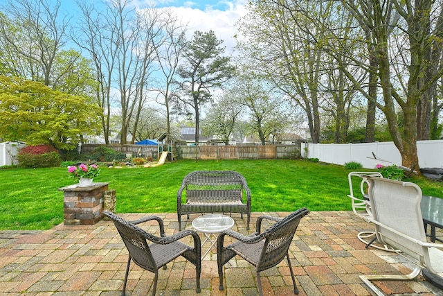view of patio / terrace featuring a playground and a fenced backyard