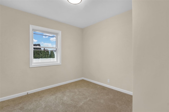 carpeted empty room with baseboards
