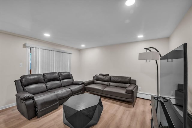 living room featuring recessed lighting, baseboards, and light wood-type flooring
