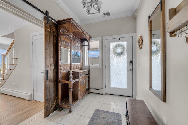 foyer entrance featuring a baseboard heating unit, visible vents, crown molding, and a barn door